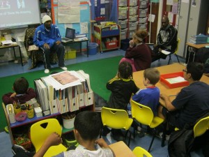 Children enjoying listening to a guest speaker in a classroom during SHOCK programme